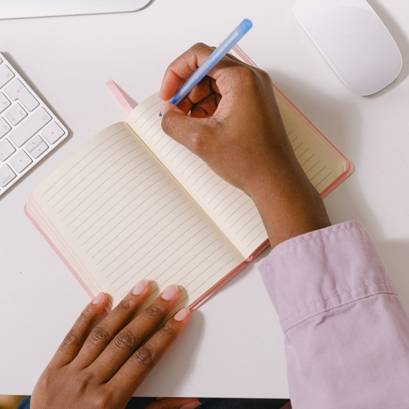 Writing notes in a notebook