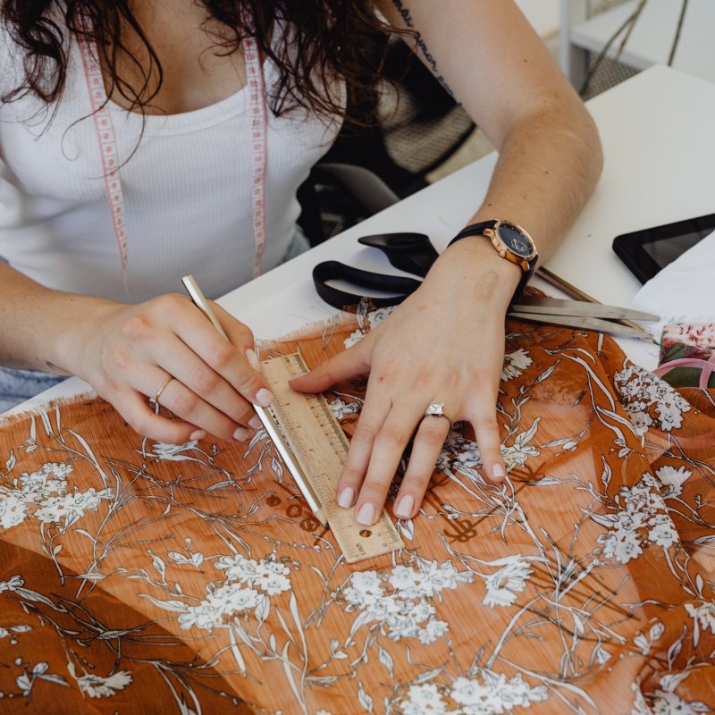 Designer measuring fabric in her atelier
