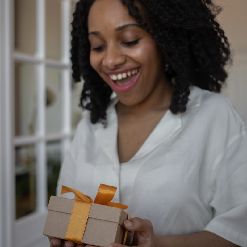 Woman opening a small gift box