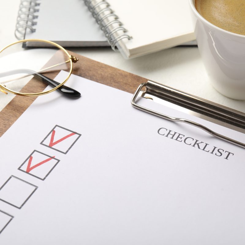 Checklist with coffee and glasses
