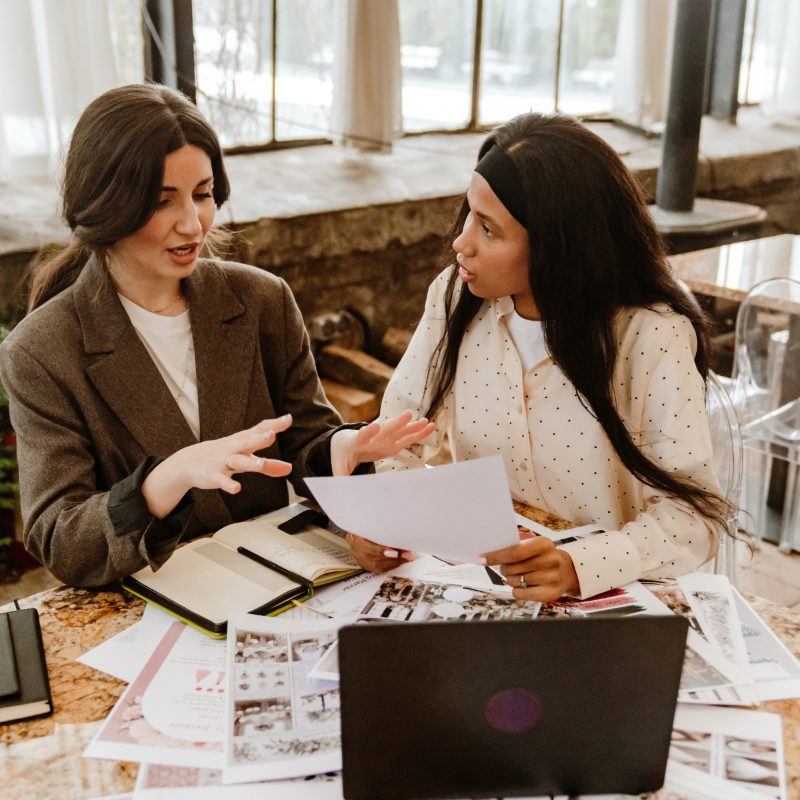 Two women sharing ideas at a table