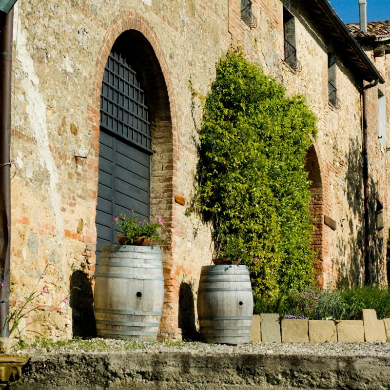 Stone farmhouse with wine barrels