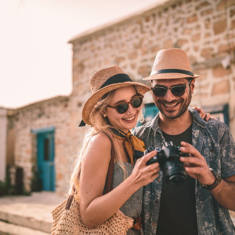 Travellers looking at a phone in an old town